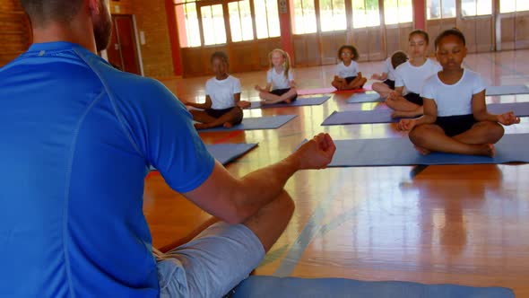 Yoga instructor teaching yoga to school kids in school 4k