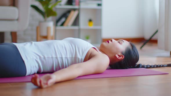 Calm of Asian woman practice yoga Dead Body or Savasana pose