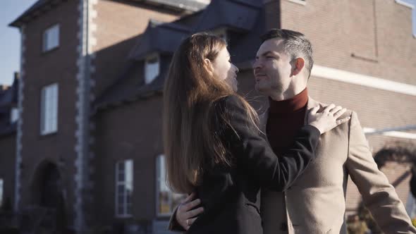 Rich Caucasian Couple with Age Difference Posing Outdoors on Sunny Day with Luxurious House at the