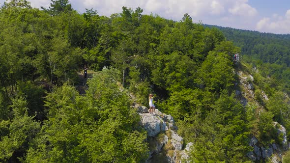 Aerial View on Couple Standing Against Amazing Nature View on Mountain Lake in on the Border of