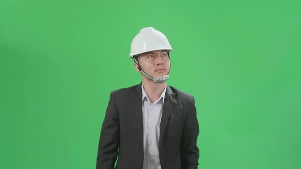 Asian Chief Engineer In The Hard Hat Walks On Green Screen Chroma Key