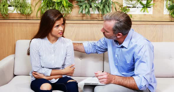 Doctor consoling female patient