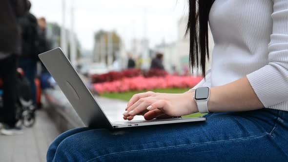 A Young Woman or Girl Working on a Laptop