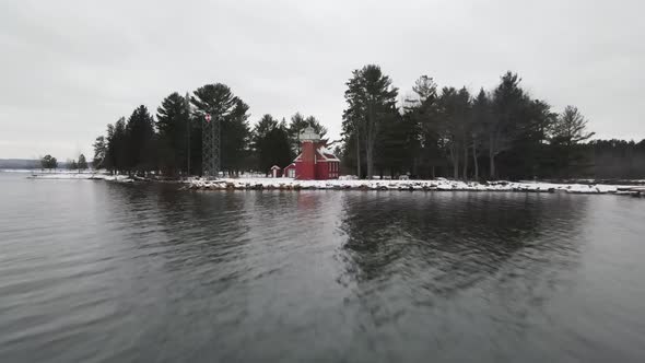 4k drone video of Sandpoint Lighthouse in Baraga, Michigan in the winter.