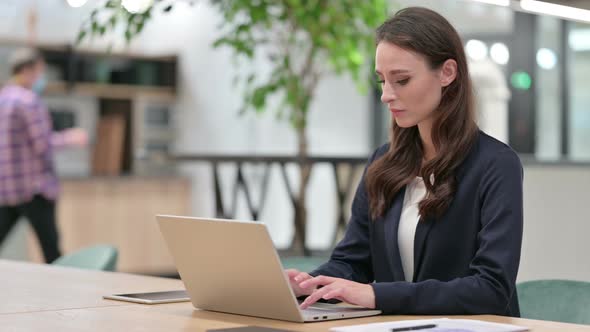 Businesswoman with Laptop at Work Coughing 