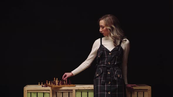 Female Chess Player Making Strategic Move While Playing Alone. medium shot