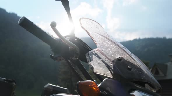 Moto Travel. Wheel Motorcycle on the Background of the Morning Sun in Mountains.