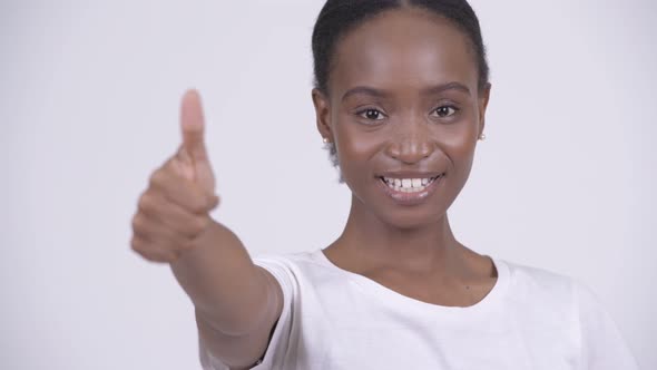 Face of Young Happy African Woman Smiling and Giving Thumbs Up