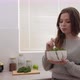 Girl eating salad and enjoying the food in the bright kitchen. Vegetarian, healthy and raw food - VideoHive Item for Sale