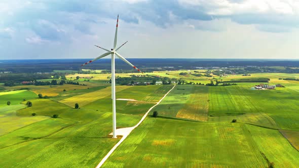 Wind turbines on green field in summer, Poland from above