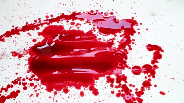 red ink splashing on white background artistic shot