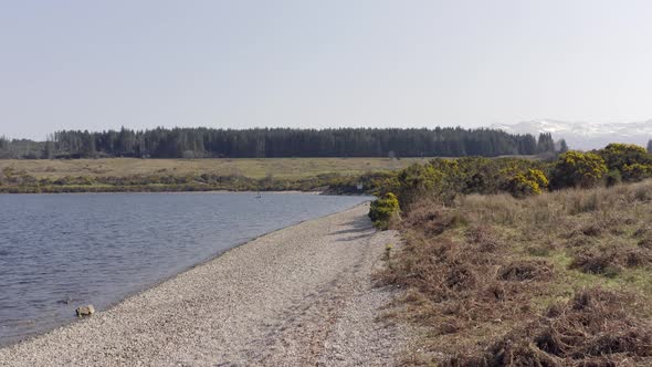 Empty Pebble Shores of a Lake Aerial Flyover