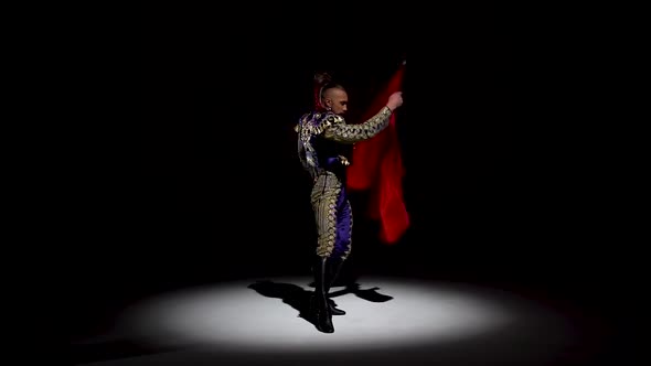 Torero in Blue and Gold Suit or Typical Spanish Bullfighter Isolated Spotlight on a Black Background