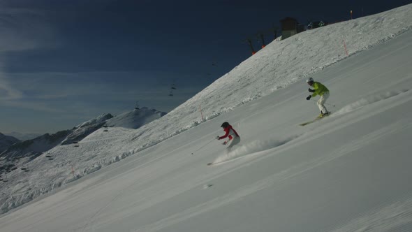 Skiing Couple on Empty Piste