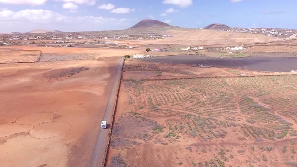 Big motorhome crossing astonishing red desert in Fuerteventura, Spain