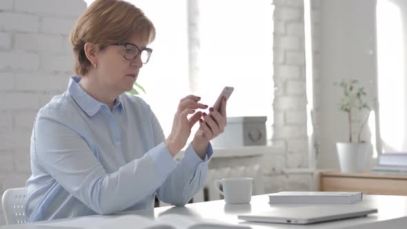 Old Woman Browsing Smartphone