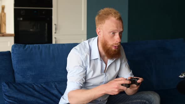 Excited Smiling Young Redhead Man Win in Video Game and Feel Happy