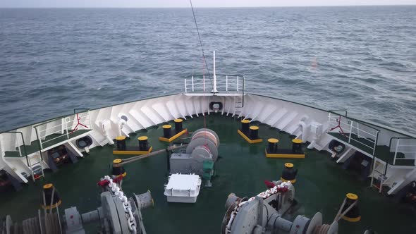 Ship's Bow with All the Winches, Ropes and Anchor Moving Through the Waves