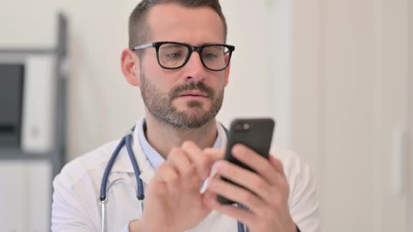 Portrait of Male Doctor Using Smartphone