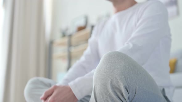 Close Up of Peaceful Man Meditating on Yoga Mat at Home