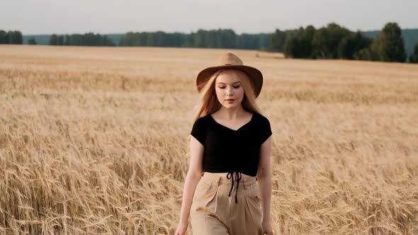 Romantic and Carefree Young Woman in Slow Motion Video Walking on Field Wheat Enjoying Freedom