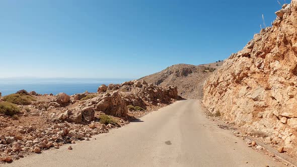 Coast POV driving in the mountains on a sunny summer day. Zig-zag curve road