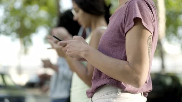 Closeup Shot of Woman Using Smartphone While Walking