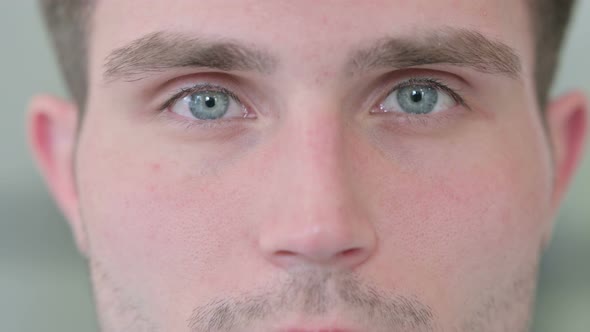 Close Up of Blinking Eyes of Attractive Young Man