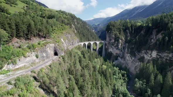 Landwasser Viaduct in Swiss Alps in Summer Aerial View on Green Mountain Valley