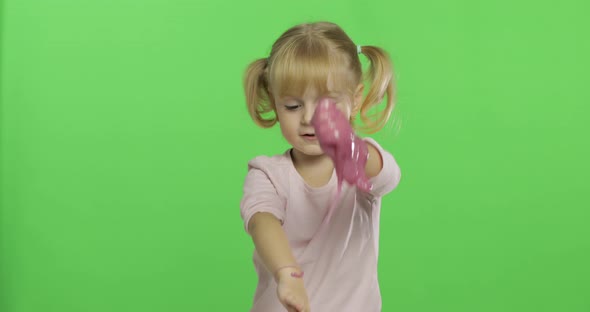 Kid Playing with Hand Made Toy Slime. Child Having Fun Making Pink Slime
