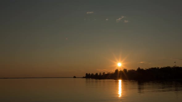 Beautiful Sunset By The Bank Of A Calm River, Time Lapse