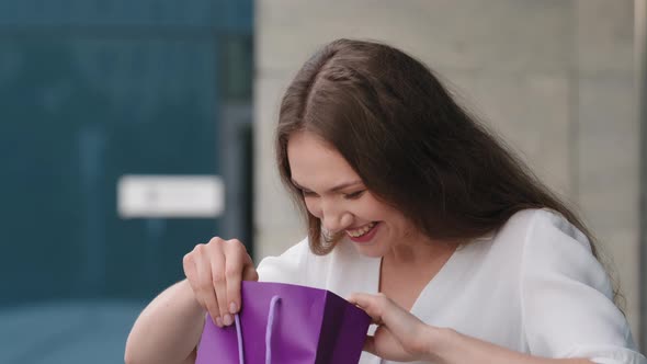 Female Portrait Outdoors Caucasian Surprised Happy Exited Birthday Girl Woman Receive Gift Bag with