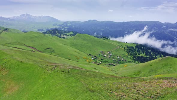 Flying Over Sloping Mountain Pass With Green Pastures In Highland Countryside Of Georgia