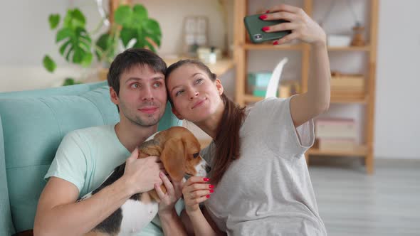 Family Taking Selfie with Dog and Sitting on Couch in Apartment Room Spbi