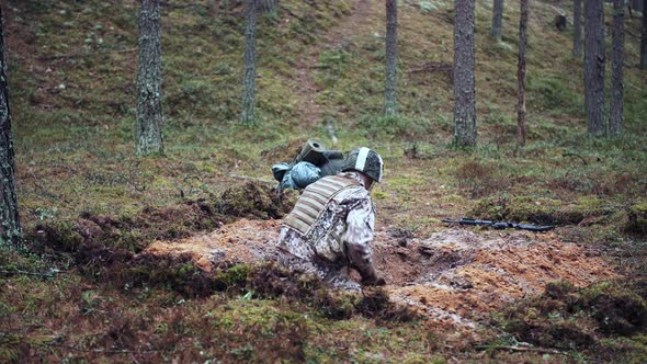 One Soldier Digs a Trench in a Pine Forest