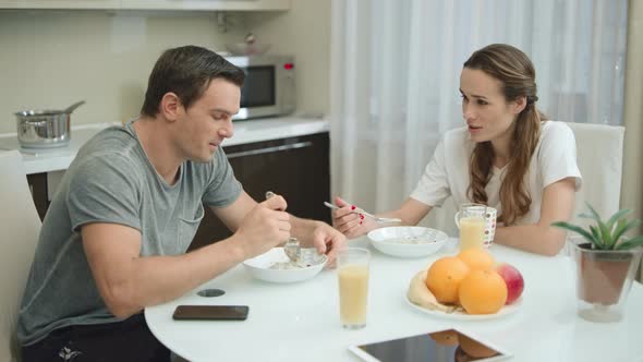 Happy Couple Having Breakfast Together at Home.