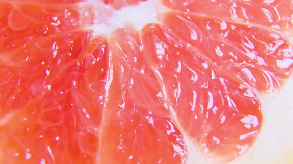 Red Citrus Fruit Slices of Grapefruit on Rotating Surface