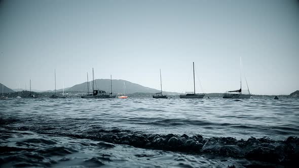 Low angle view of Lake Maggiore with small anchored boats. Italy