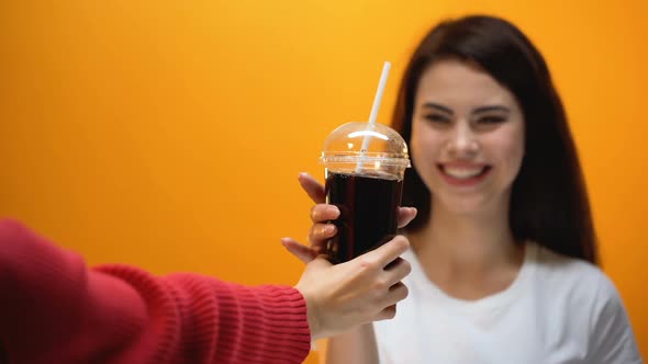 Hand Giving Soda to Young Girl, Society Accustoms Generation to Sweetened Food