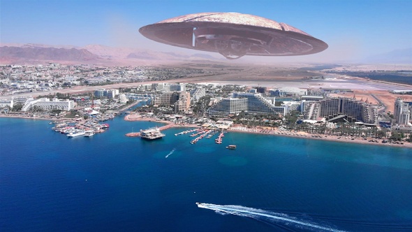 Alien Saucer Over Large City Near sea