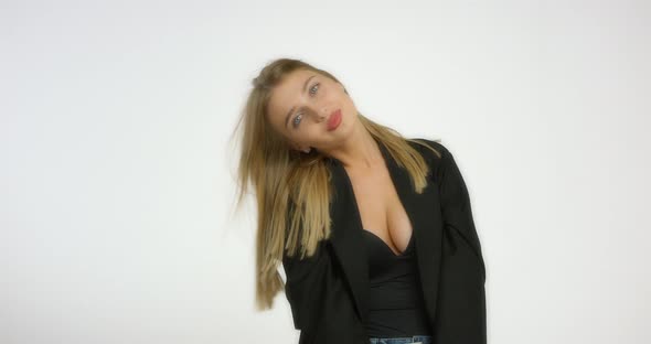 Beautiful Young Woman Poses in the Studio on Camera on a White Background