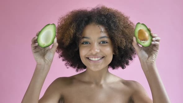 Professional Afro American Model Poses with Avocado Halves