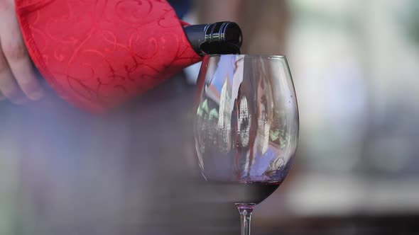 Red Wine. Waiter Pouring Wine In Glass At Restaurant Closeup