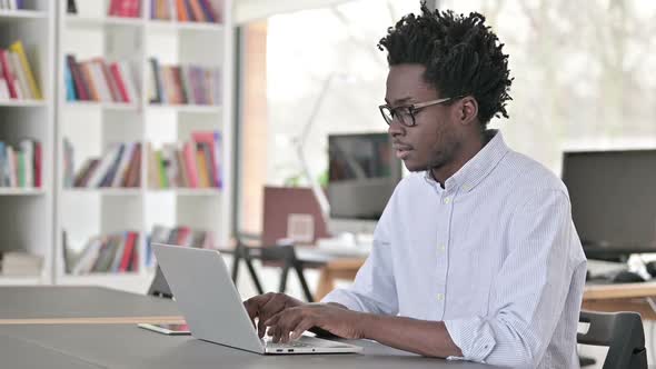 Thumbs Up By African Man Working on Laptop