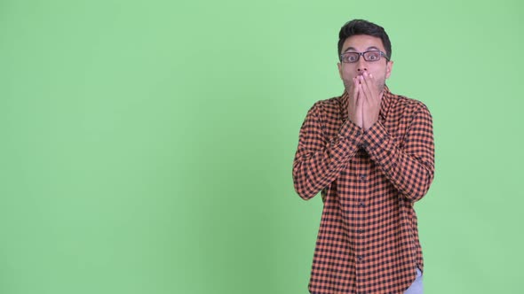 Young Hispanic Hipster Man Showing Something and Looking Shocked