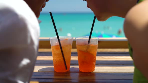 Two Women Drink Cocktails