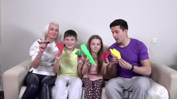 Family Launches Colorful Paper Airplanes in the Room, Slowmotion
