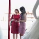 Mother and daughter looking at wedding dress in shop window - VideoHive Item for Sale
