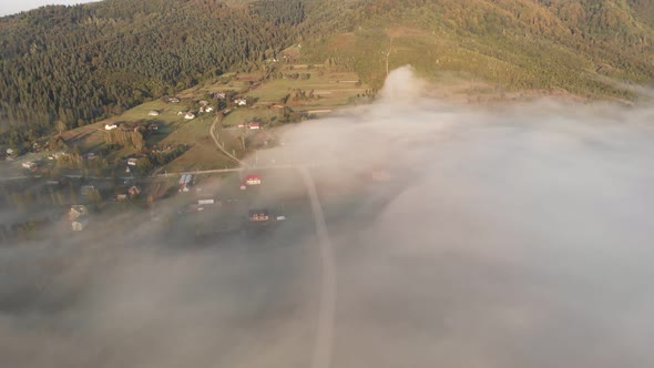 Aerial View Flight Over Clouds Between Mountains