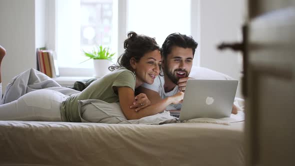 Happy Married Caucasian Couple Using Laptop at Home Spbd